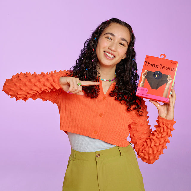 teen model holding a boxed pair of thinx teens period underwear